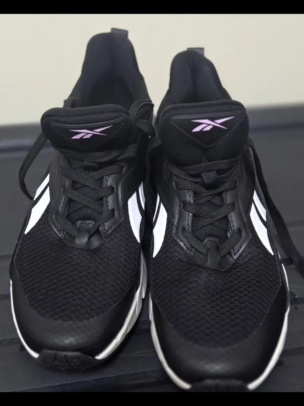 Reebok Black Athletic Sneakers with White Stripes and Pink Logo